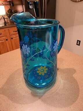 Vintage turquoise Libbey glass pitcher with painted design.